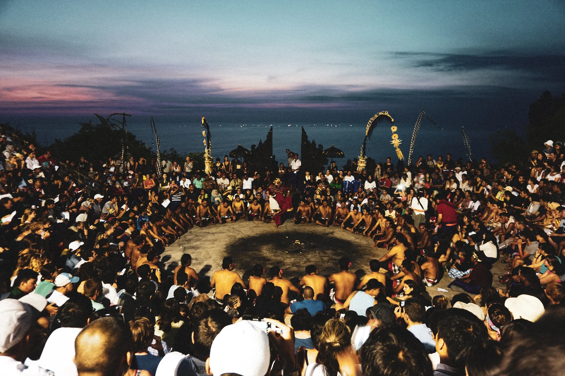 The Kecak dance chant-circle performing at sunset on the clifftop at Uluwatu Temple, Bali